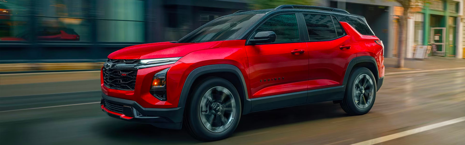 Chevrolet Equinox driving along a bustling city street, showcasing its sleek design and urban environment.